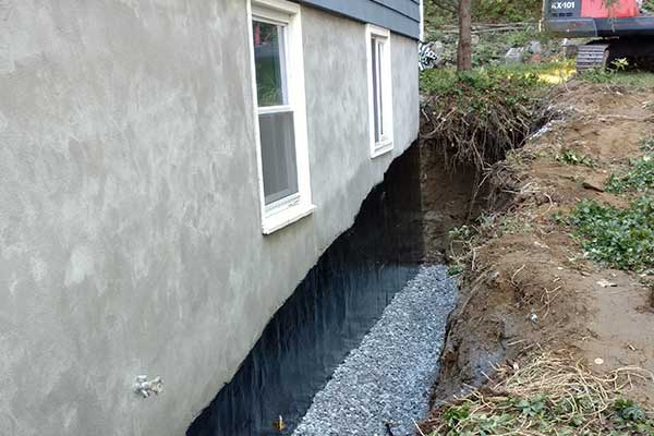 A trench excavated next to a house