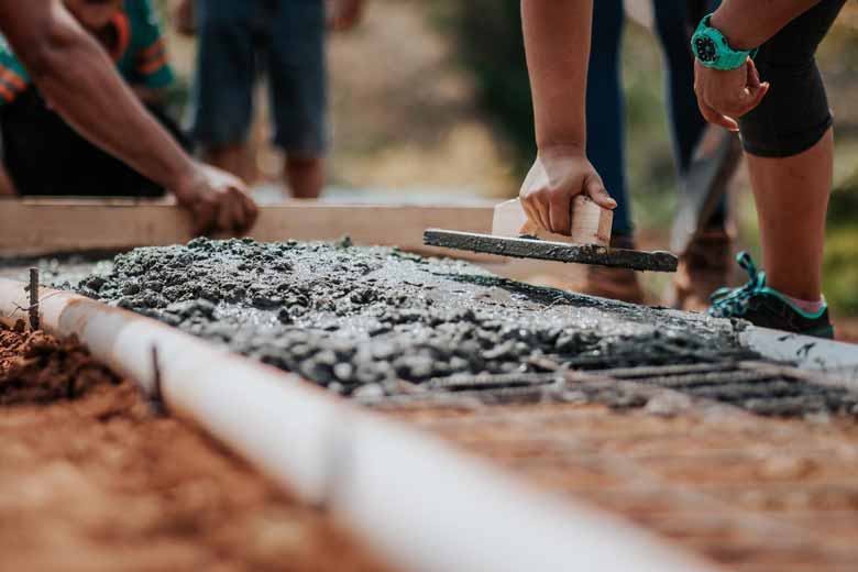 A team of people working with wet concrete