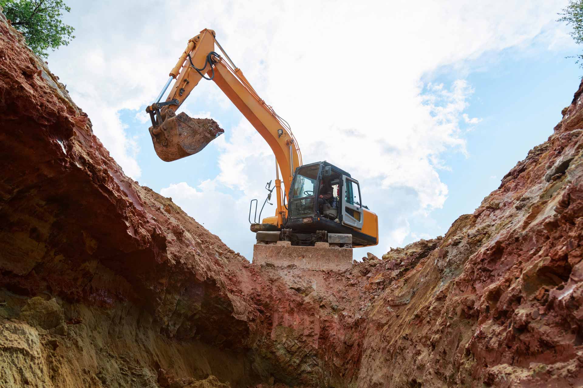 Low-angle shot on excavator, shot from inside of a hole